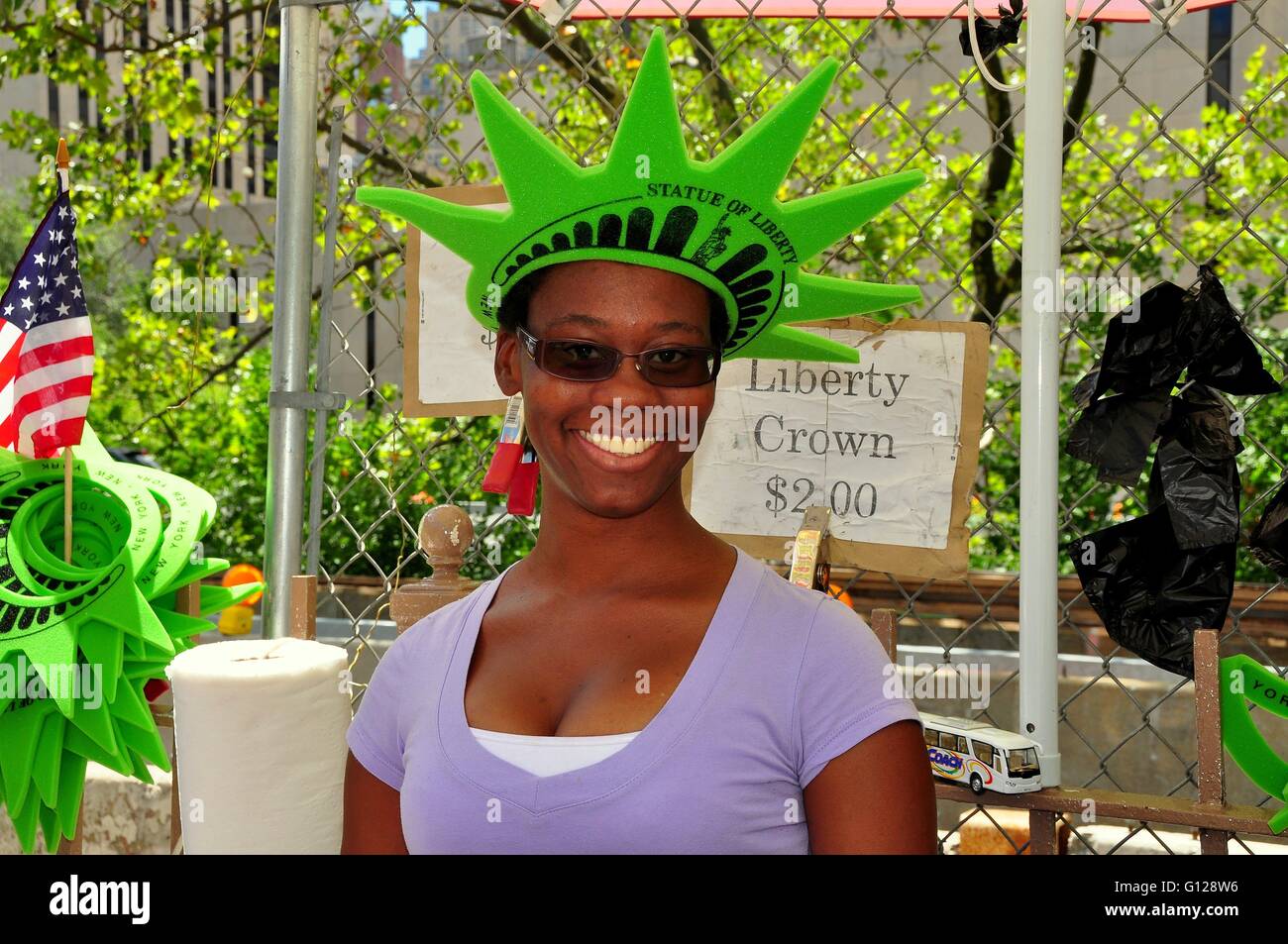 New York City :  Smiling woman selling souvenir foam rubber Statue of Liberty crowns on the Brooklyn Bridge Stock Photo