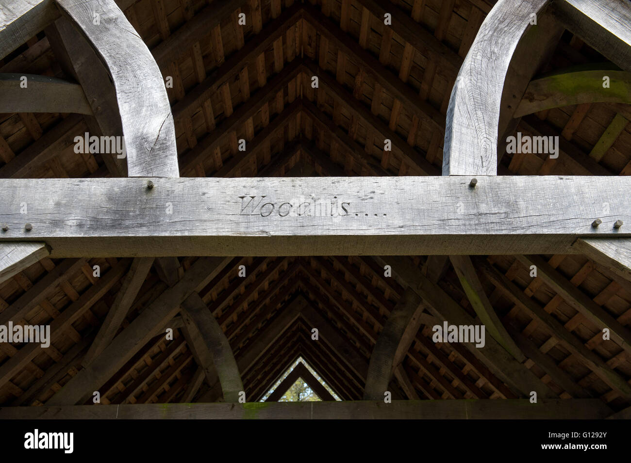 Timber framed shelter with the words WOOD IS... carved onto a cross beam. Westonbirt Arboretum, Gloucestershire, England Stock Photo