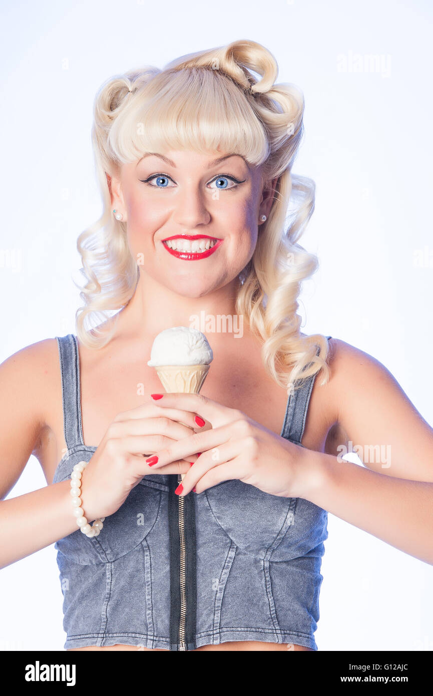 Blond fifties style retro pinup on blue background Stock Photo
