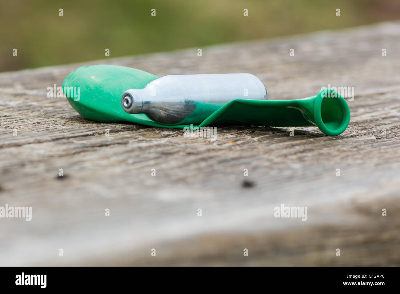 Balloon and nitrous oxide canister after use. Drug paraphernalia