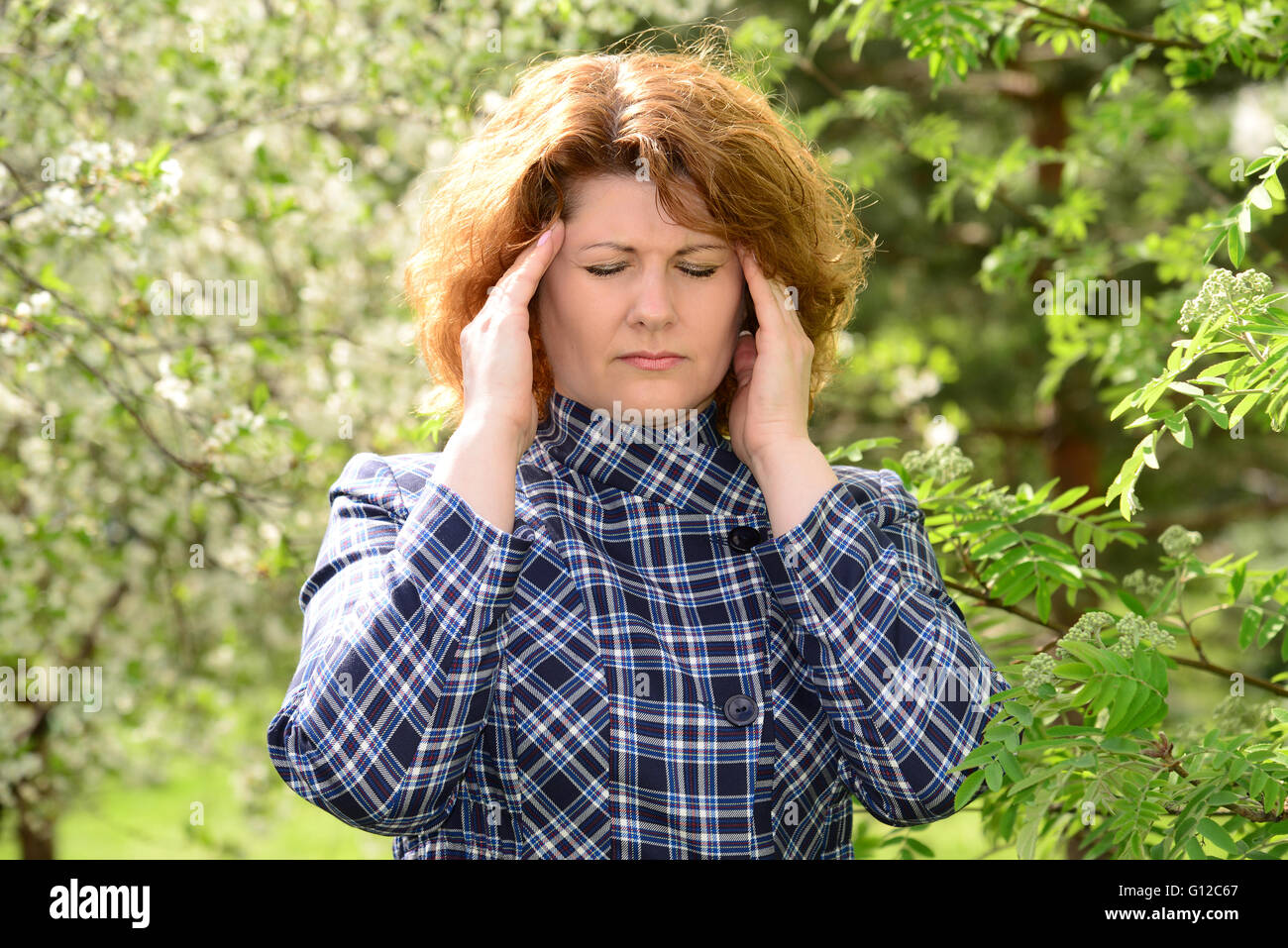 woman with a headache on  nature of the spring Stock Photo