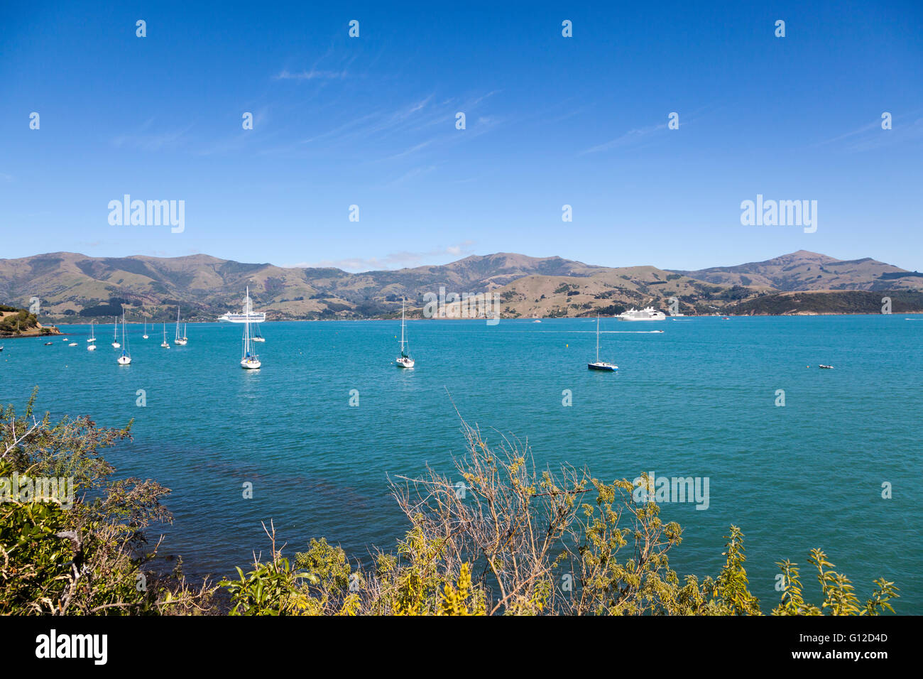 Akaroa Harbour, with Le Soleal and the Golden Princess cruise ships in the background, New Zealand Stock Photo