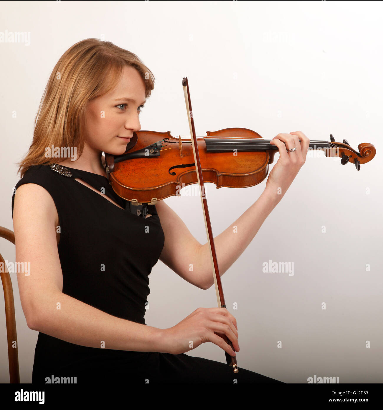 Playing the violin with the bow. Arco. playing position bowing. Stock Photo