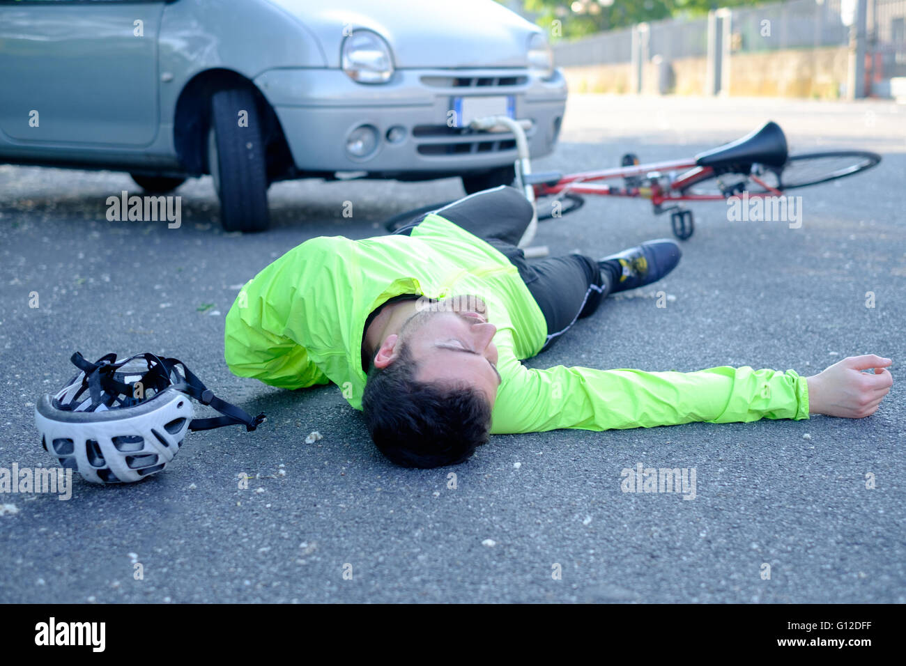 fainted aching man after bicycle accident on the asphalt Stock Photo