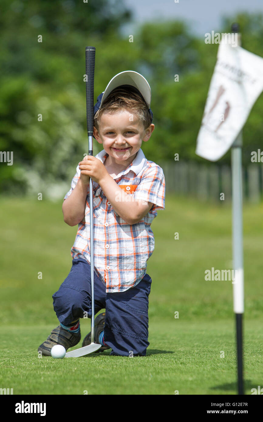 young boy and father playing golf Stock Photo