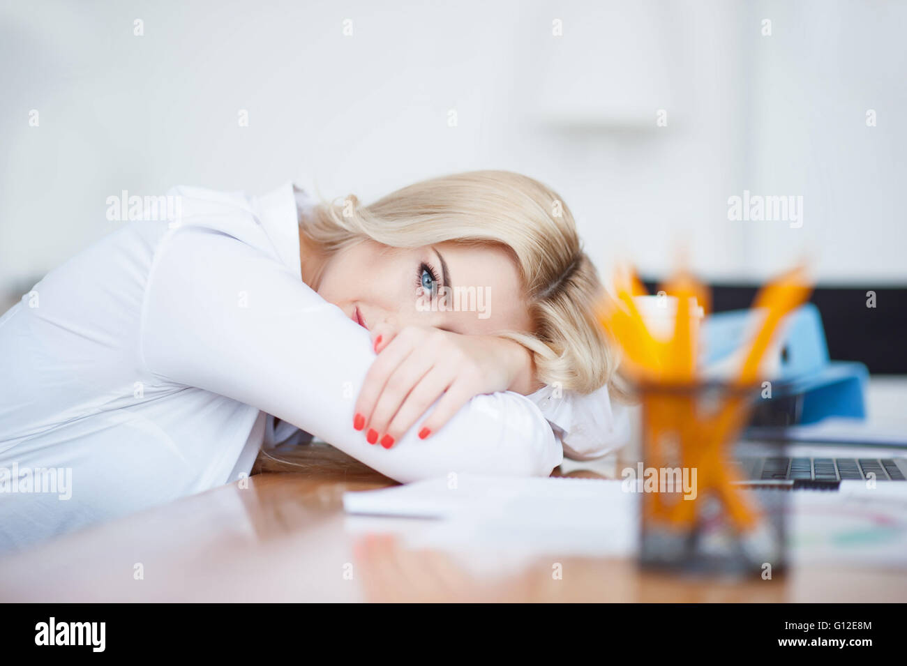 Attractive woman leaning on the table Stock Photo
