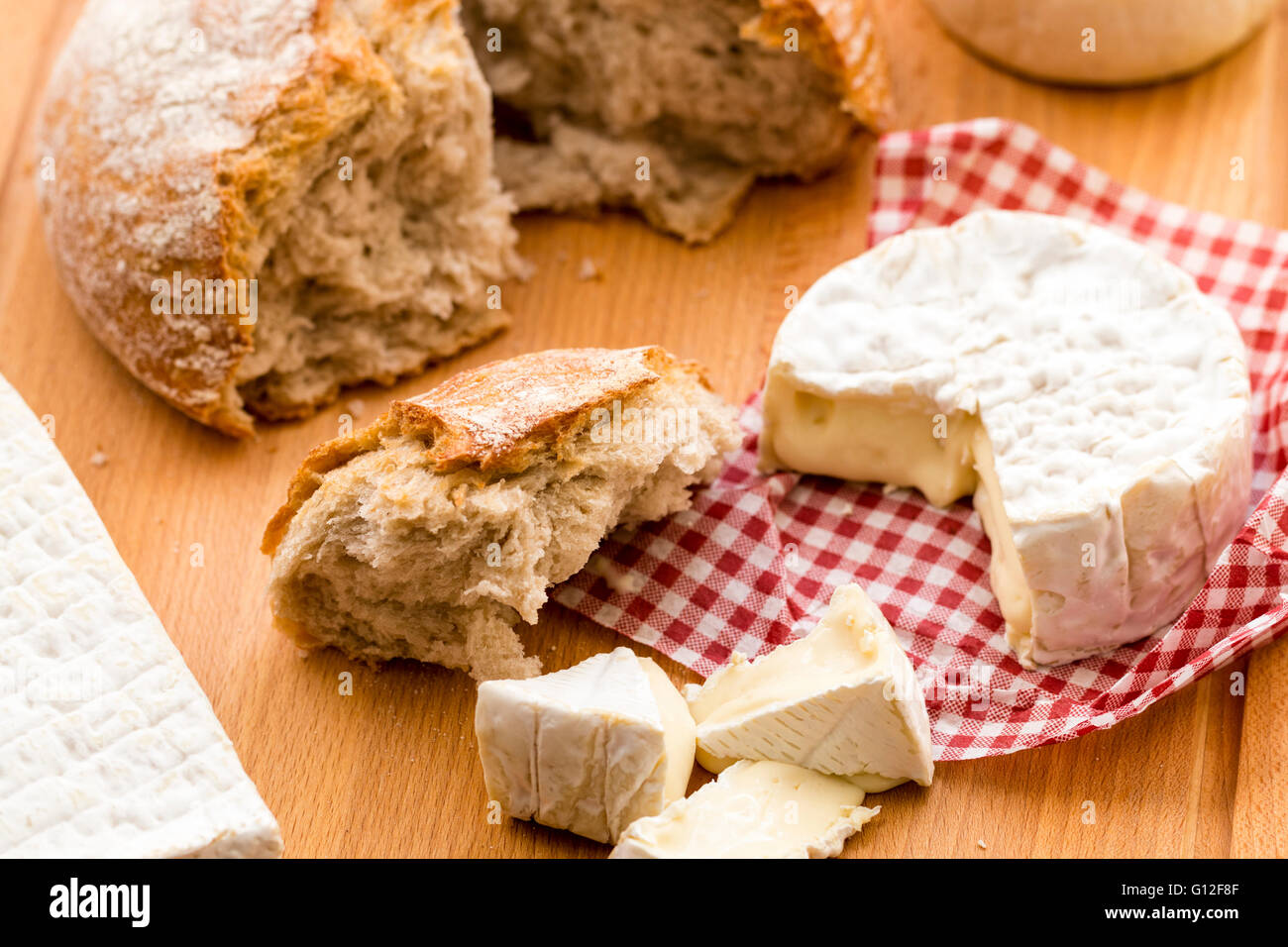 Selection of Cheeses. Round Camembert with pieces cut out, and Brie