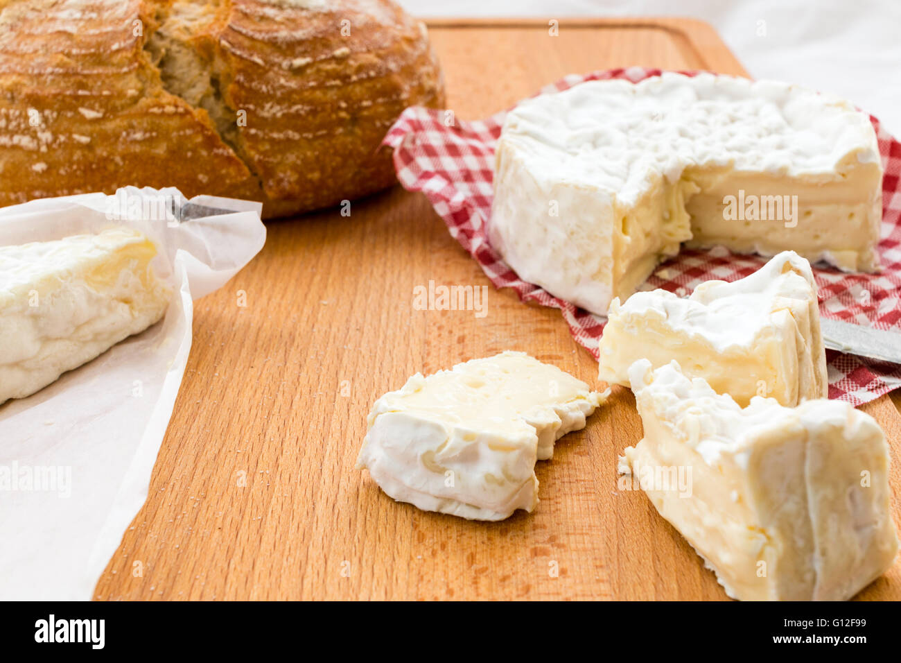 Selection of Cheeses. Round Camembert with pieces cut out, and Brie