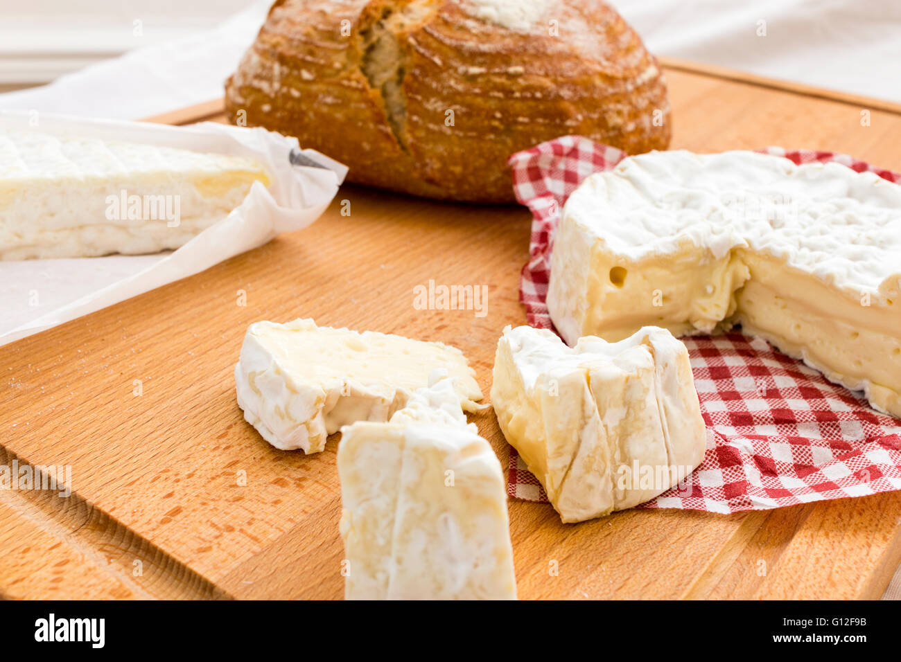 Selection of Cheeses. Round Camembert with pieces cut out, and Brie