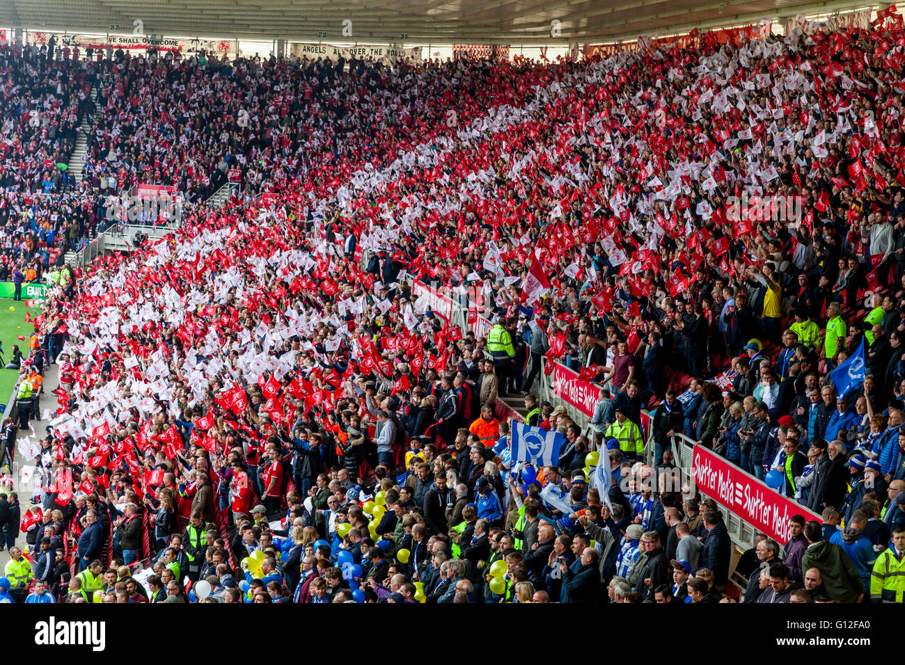 Middlesborough FC Football Fans Waving Flags At The Riverside Stadium, Middlesborough, North Yorkshire, UK Stock Photo