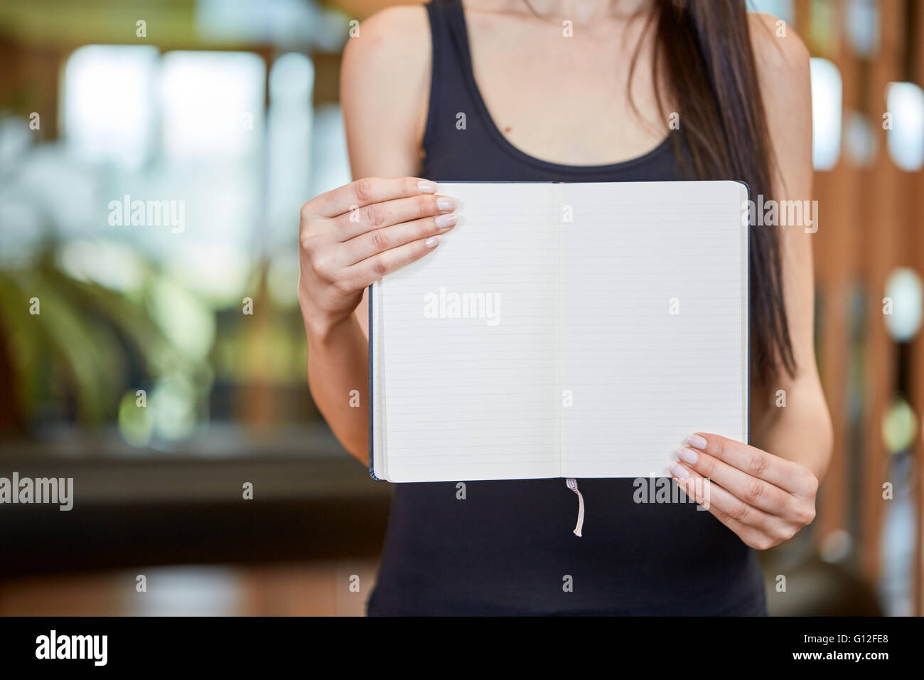 Young caucasian woman holding and showing book with white pages Stock ...