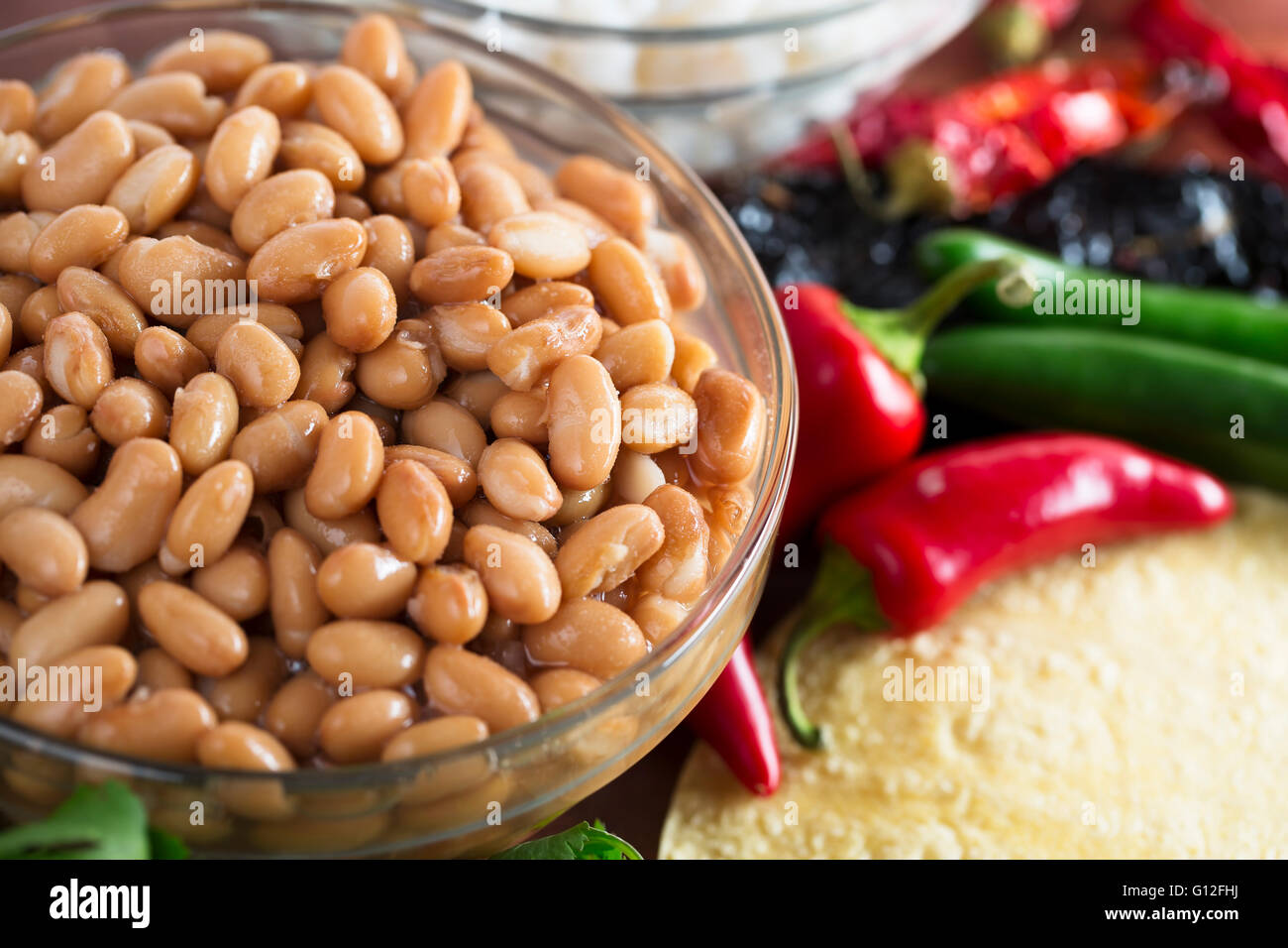 Cooked pinto beans and other ingredients for Mexican cooking. Stock Photo