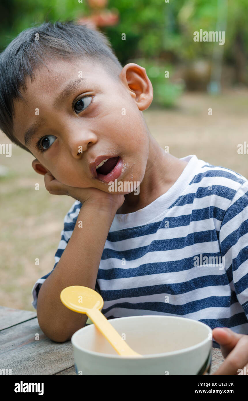 Asian Child Waiting to Eat Breakfast. Stock Photo