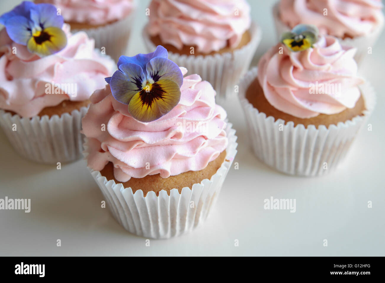 Homemade Pink Frosting Vanilla Cupcakes With Edible Flowers Stock Photo Alamy