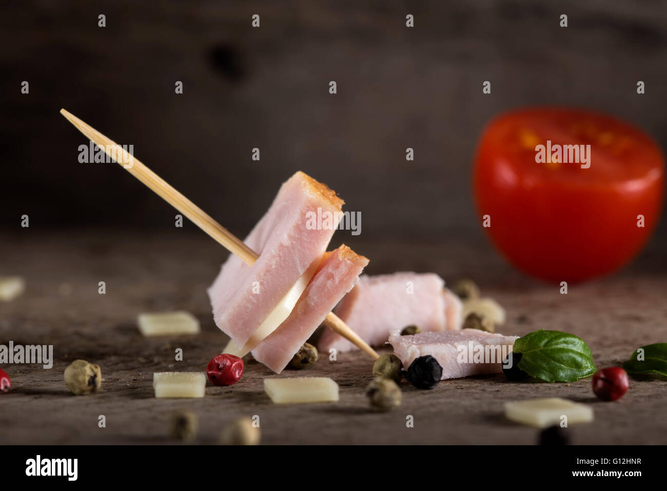 Mini ham and cheese appetizer with spices over wooden background Stock Photo