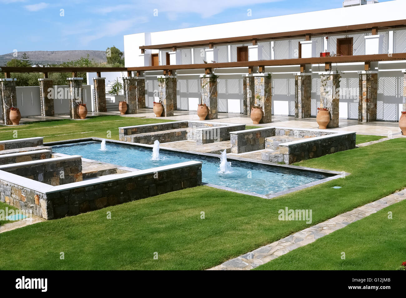 HERAKLION, CRETE, GREECE - MAY 13, 2014: The blue sky, modern building of villa with terraces, swimming-pool and fountains. Stock Photo