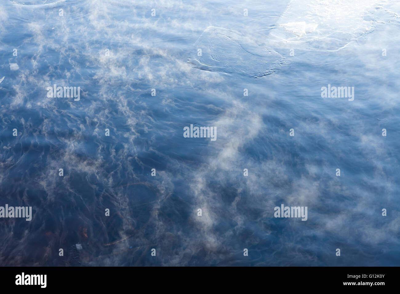 Water vapor on surface of cold icy water at sunny cold winter day Stock Photo