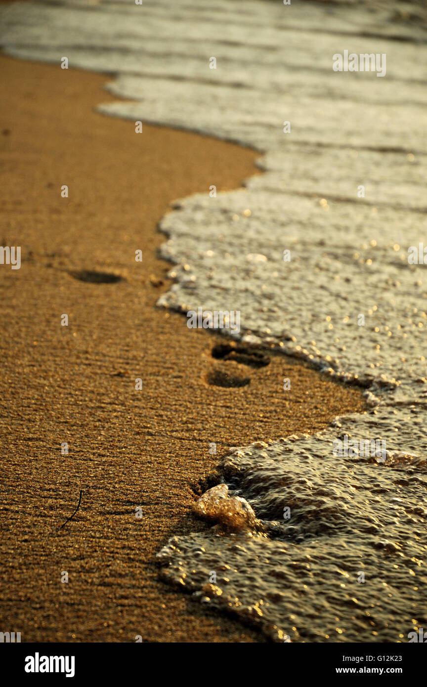 Waves erasing footprints on the shore of Lake Malawi at Cape Maclear Stock Photo