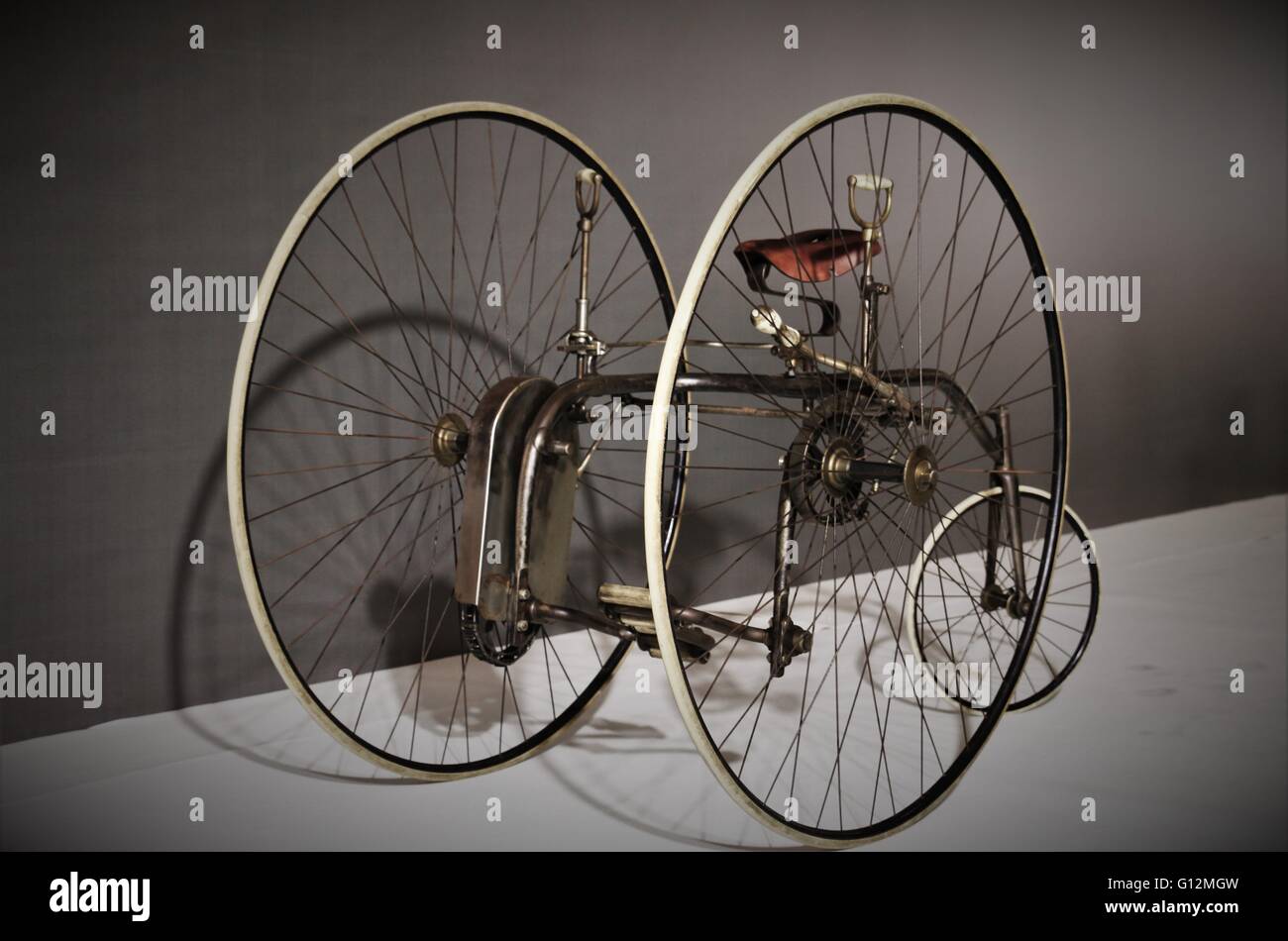 Vintage bicycle (Antique bike)with big wheels.Gray background. Captured in Shanghai formula one exhibition, China, April 2016. Stock Photo