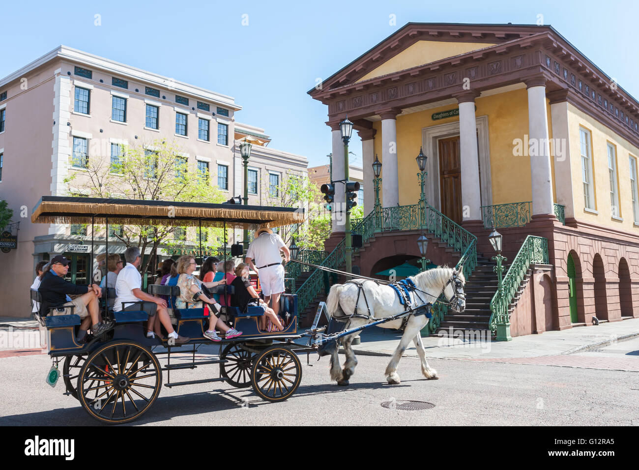 Tourists take a horse-drawn carriage tour past the historic Charleston City Market in Charleston, South Carolina. Stock Photo