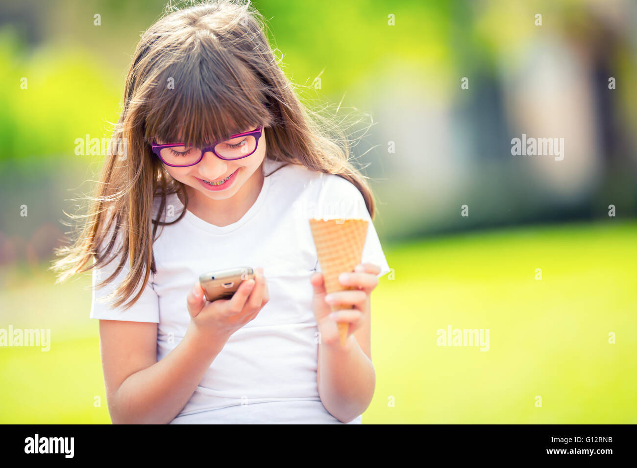 Happy pre-teen young girl. Cute little girl in the city on a sunny day. Portrait young girl. Toned image. Stock Photo