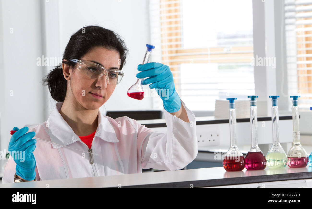 Forensic scientists examining and testing samples Stock Photo