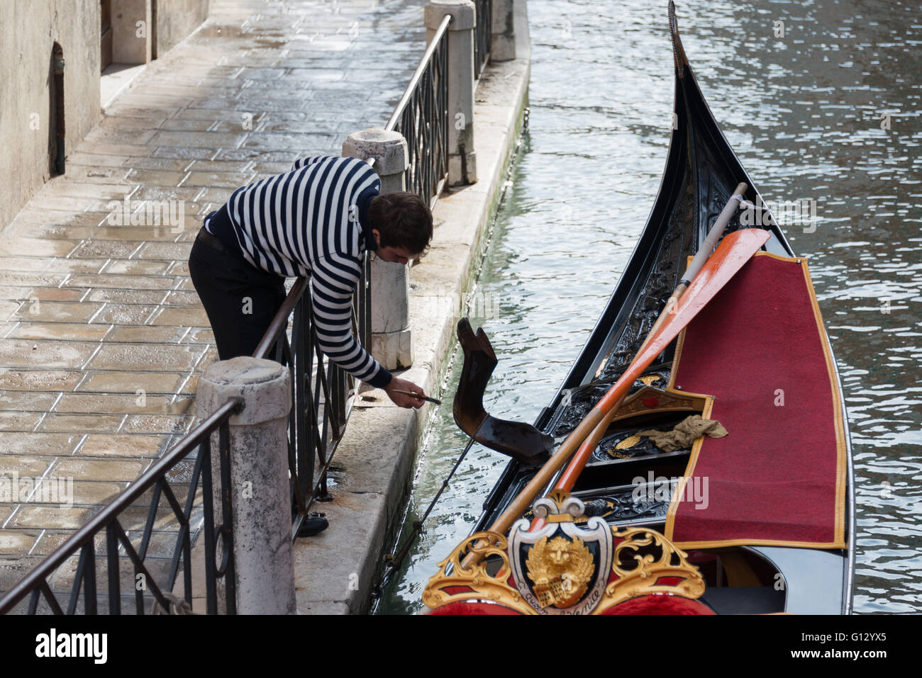 A Gondolier Fixing His Boat on a Canal Stock Photo Alamy