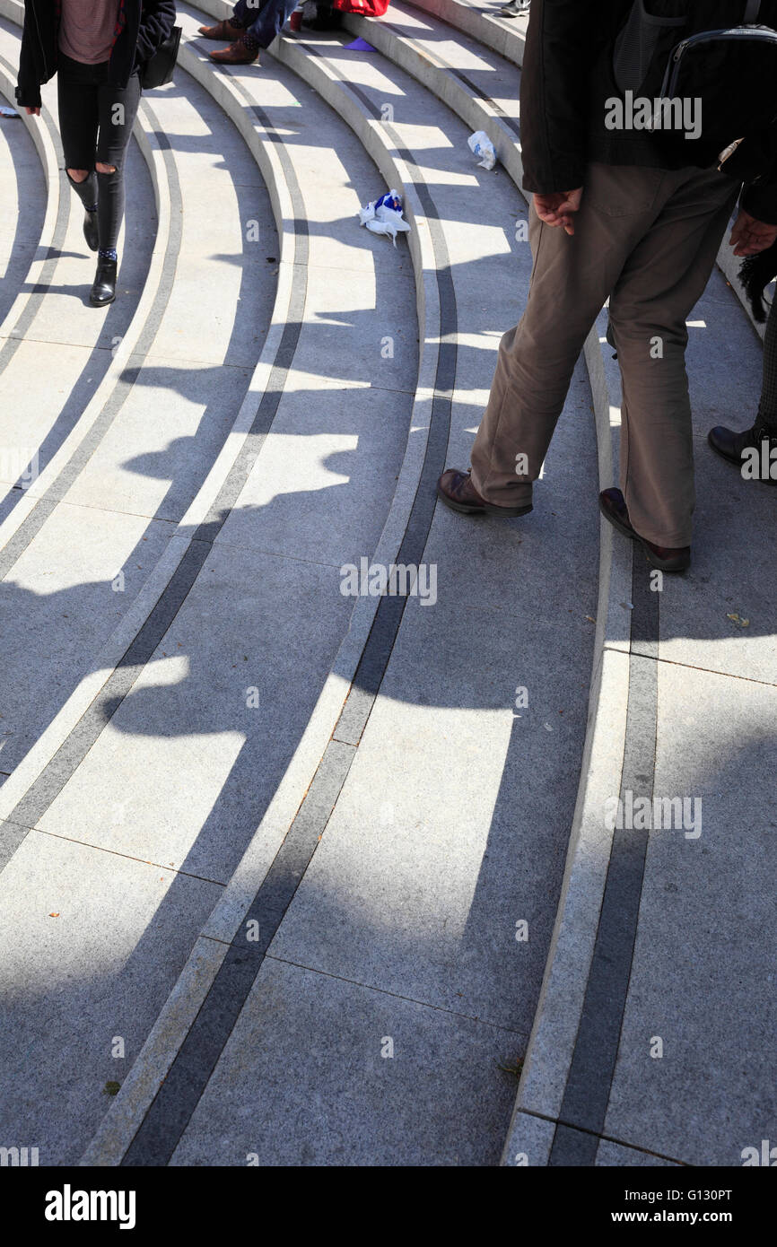 Shadows of people on the curved concrete steps outside the Forum in Norwich, Norfolk, UK. Stock Photo