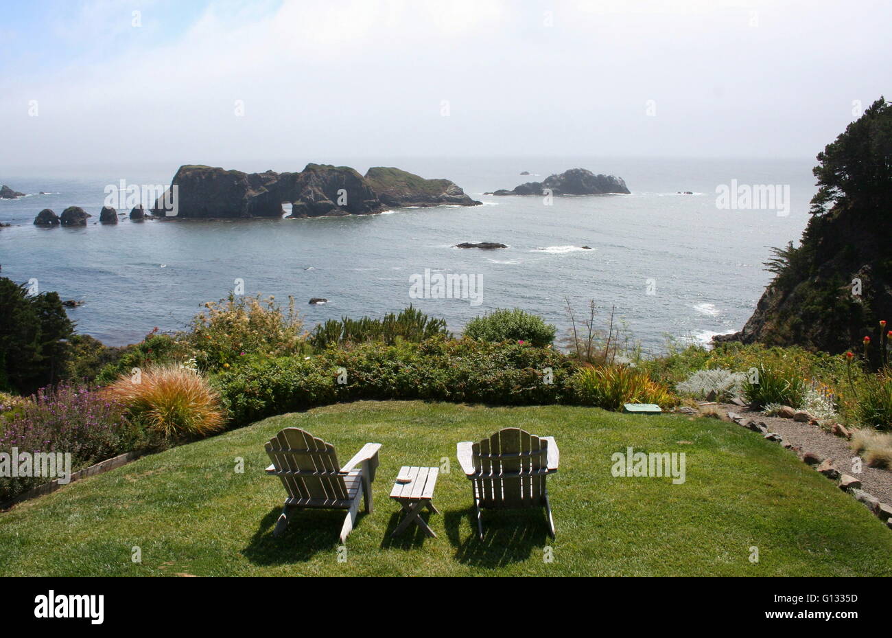 Two adirondack chairs overlook the ocean, Elk, California. Stock Photo