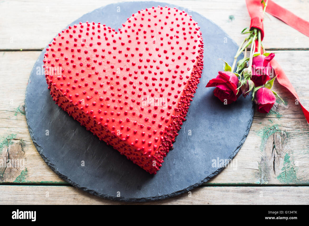 Red heat shaped chocolate cake for St. Valentines Day celebration Stock Photo