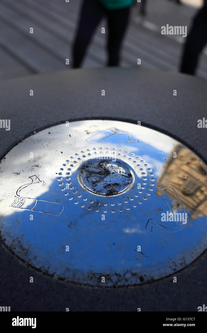 Ashtray outside with the reflection of a church and sky on silvery surface. Stock Photo