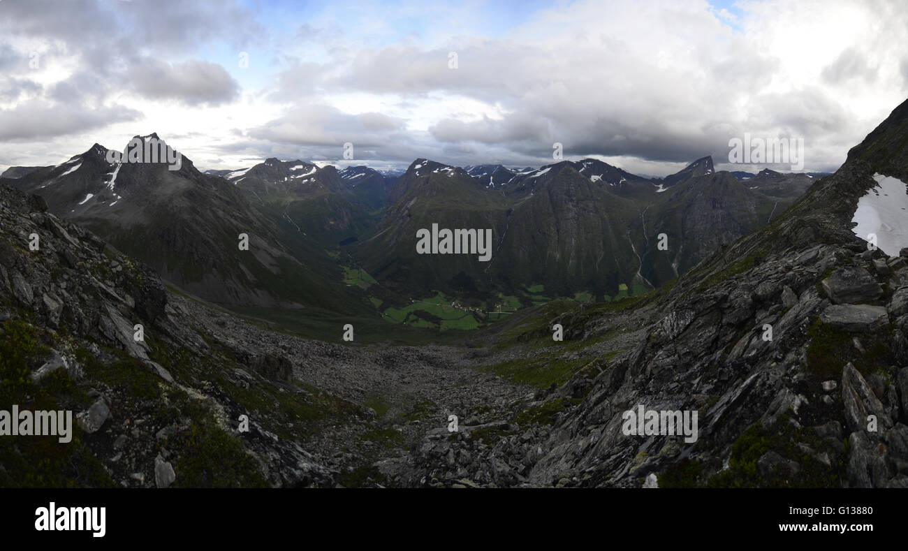View over green valleys and dark mountains on the way to Slogen Mountains. Stock Photo