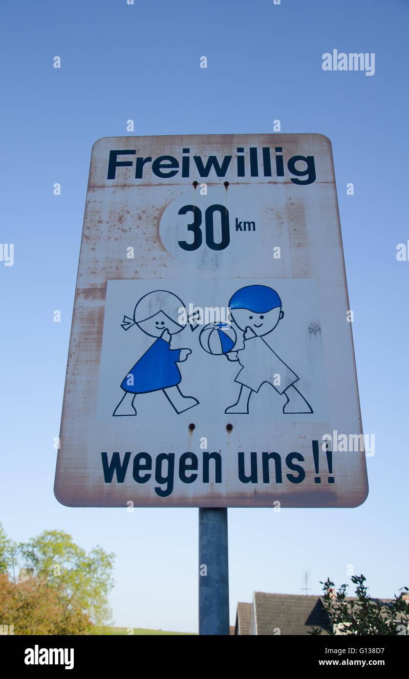 Road sign asking drivers to chose to drive 30km/h for the sake of the children Stock Photo