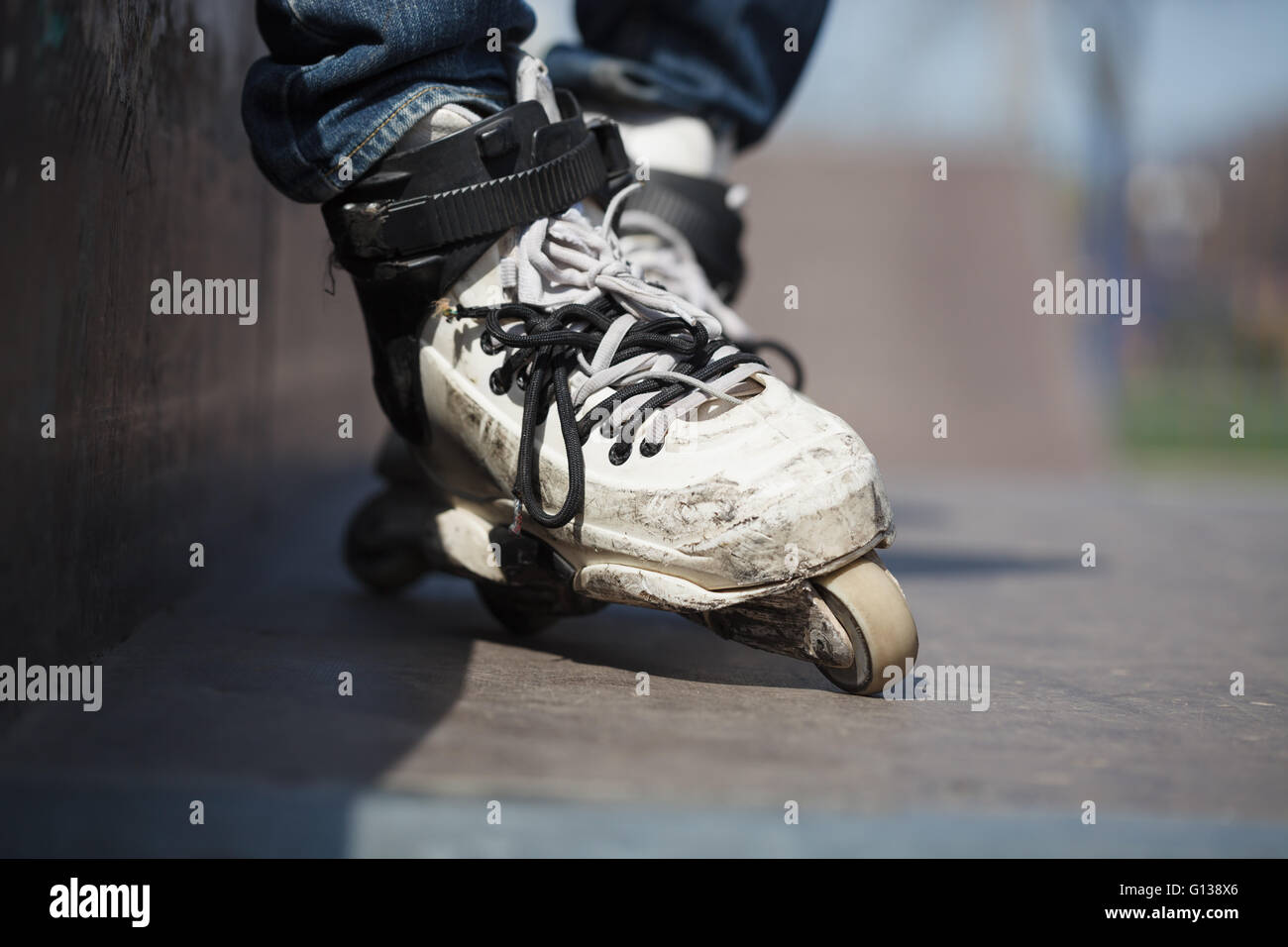 Rollerblader wearing professional extreme inline rollerblades made for tricks grinding and