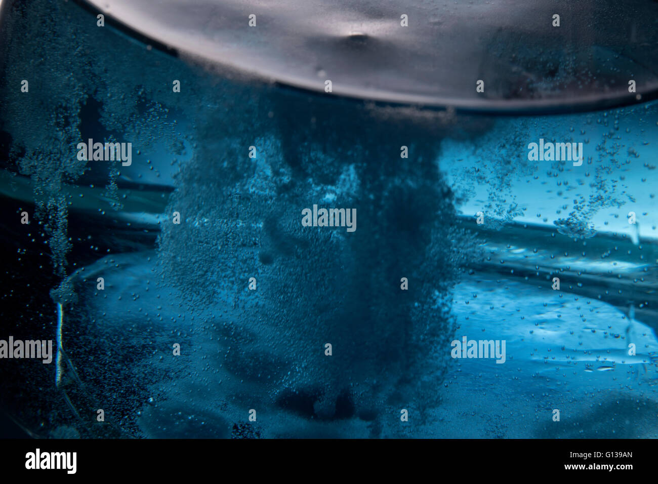 Erlenmeyer flask close up with chemical reaction fizzing Stock Photo