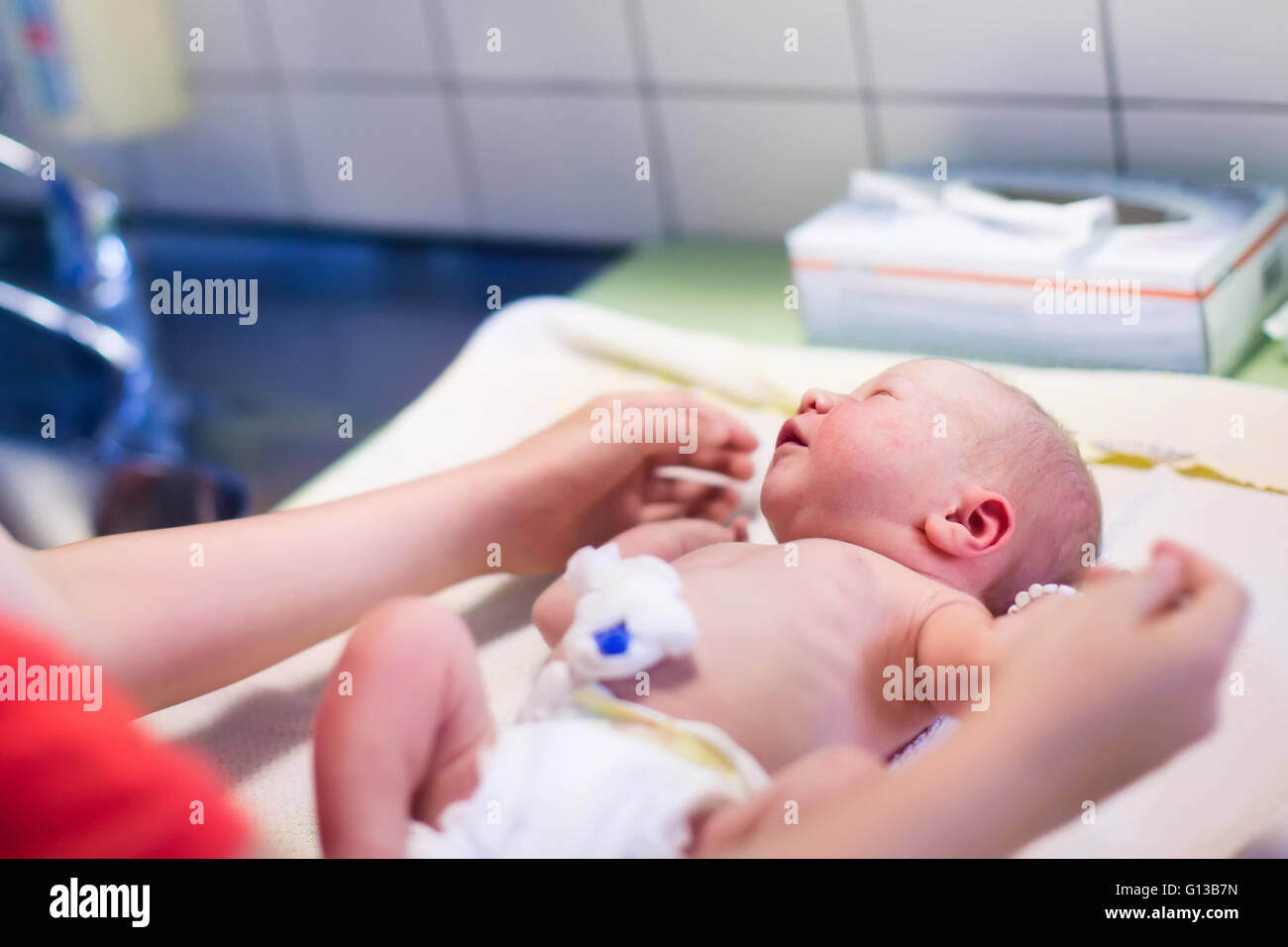 bathing a newborn baby with umbilical cord
