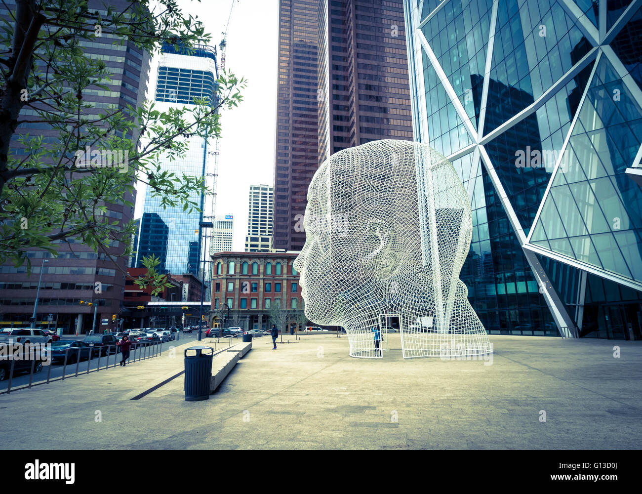 A view of the sculpture Wonderland by Jaume Plensa, in front of The Bow skyscraper in Calgary, Alberta, Canada. Stock Photo