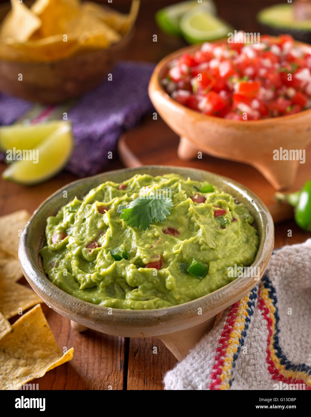 A delicious authentic mexican guacamole dip with avacado, lime, tomato