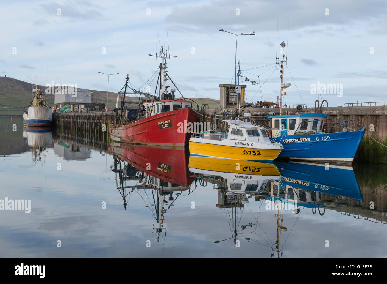 Early morning tranquility offering scenic reflections at Dingle harbor, Dingle Bay, County Kerry, Munster, Republic of Ireland. Stock Photo