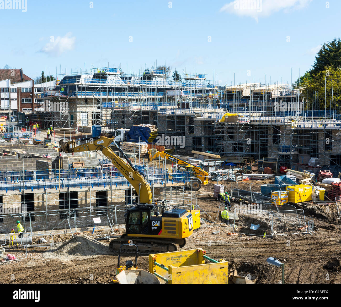 Construction site of new homes in London England. Workers working on building houses and low rise apartments/flats Stock Photo