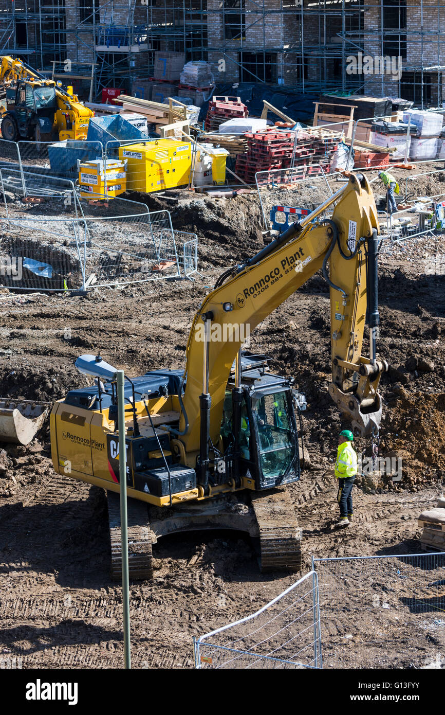 Construction site of new homes in London England. Workers working on building houses and low rise apartments/flats Stock Photo