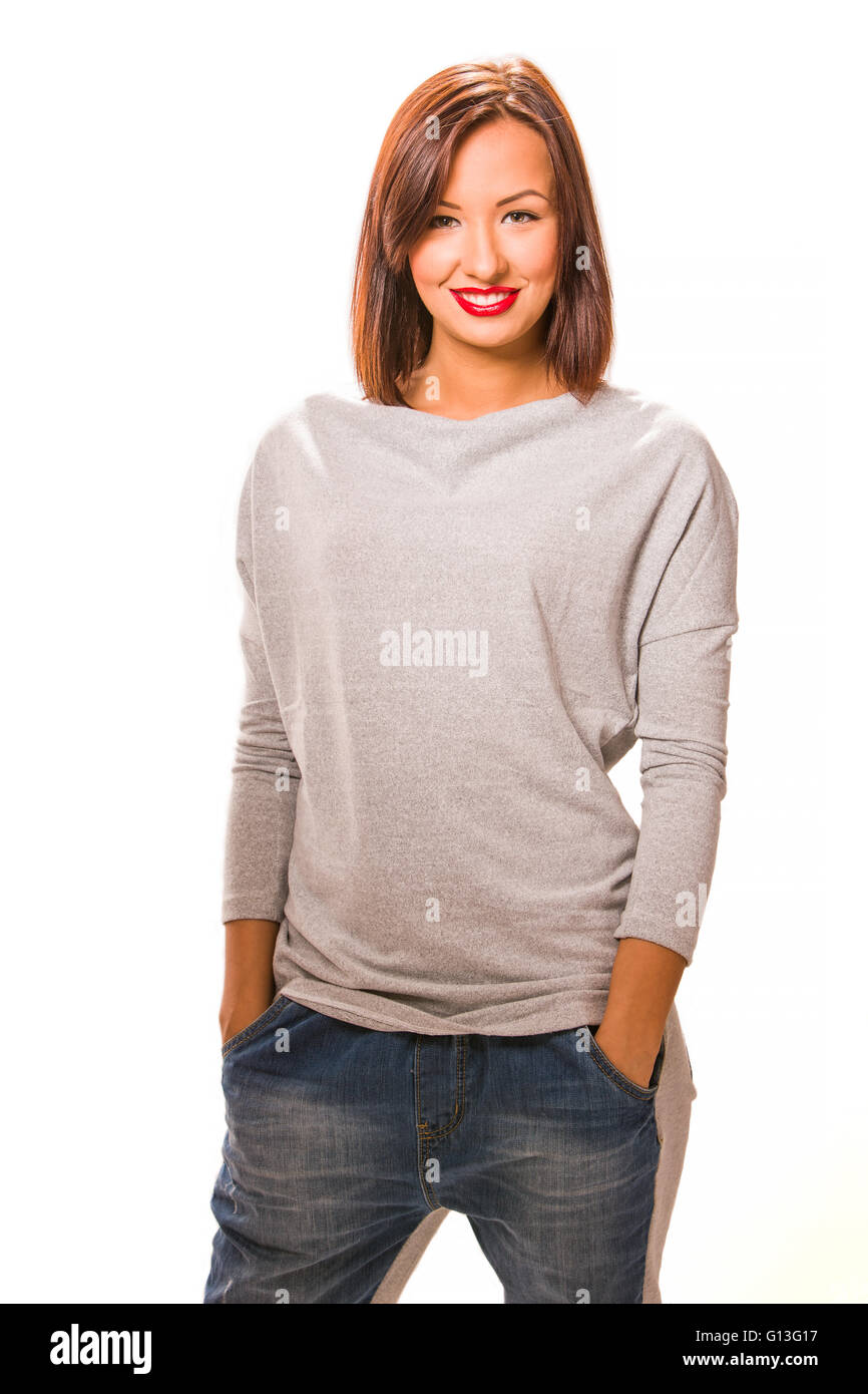 Beautiful happy young woman standing with hands in pockets, wearing ...
