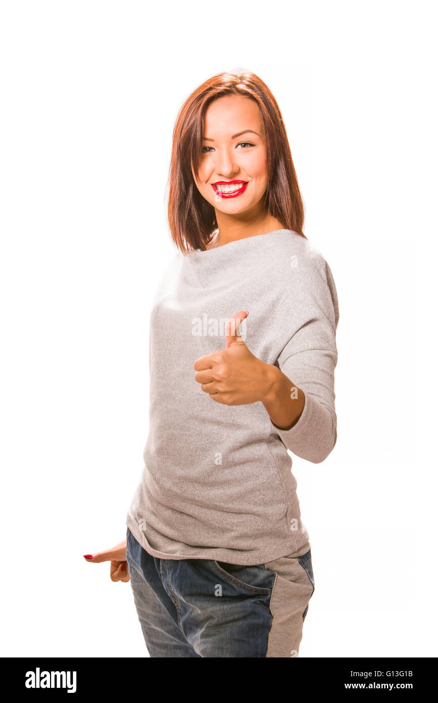 Brown hair beautiful woman with thumb up wearing grey shirt and jeans. Stock Photo