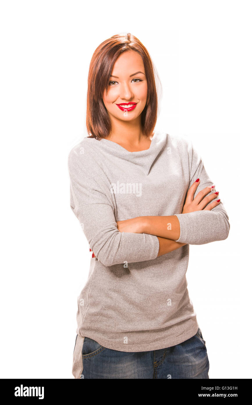 Brown hair beautiful woman with cross hands wearing grey shirt and jeans. Stock Photo