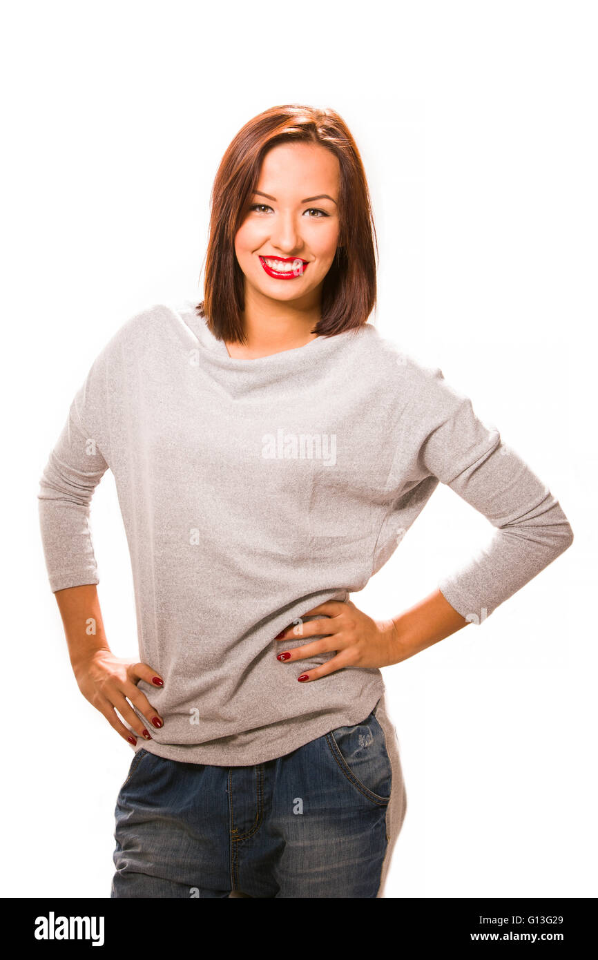 Brown hair beautiful woman with hands on hips wearing grey shirt and jeans. Stock Photo