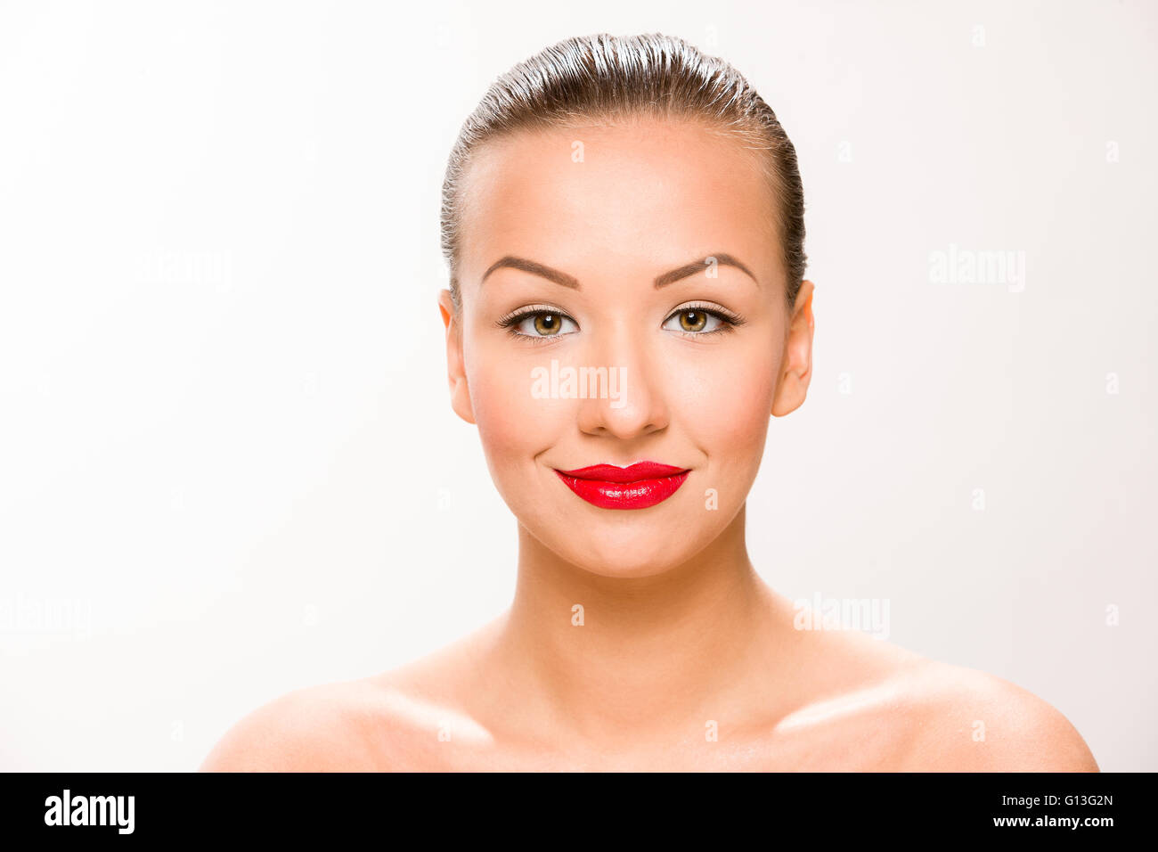 Brown sleek hair beautiful woman with with red lips looking at camera. Stock Photo