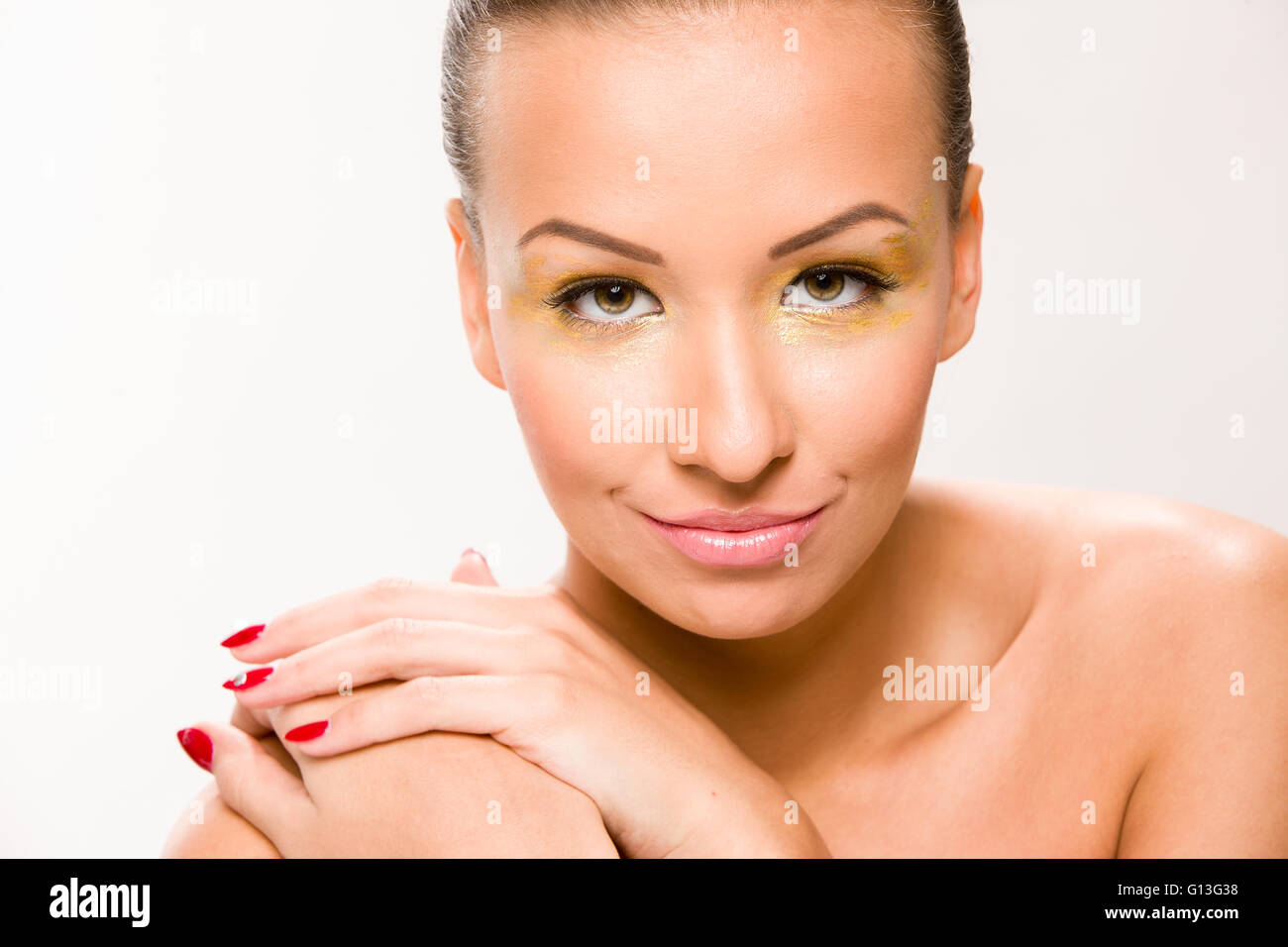 Brown sleek hair beautiful woman with hands close to face. Stock Photo