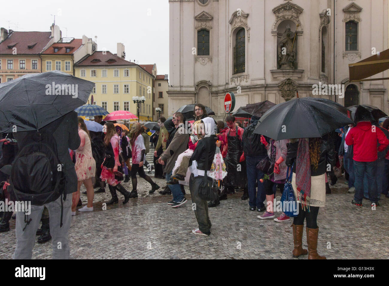 Zombie walk - Prague, Czech Republic - young woman holding a young girl in the rain Stock Photo