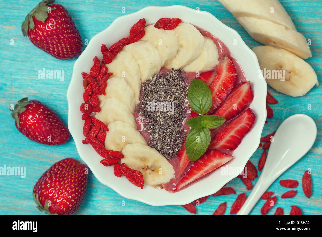 diet healthy breakfast. berry smoothie in a bowl with a banana, goji ...