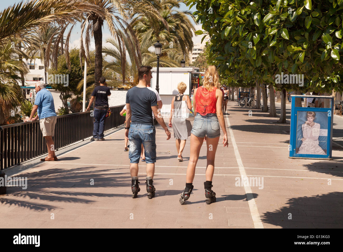 people walking and roller skating along the Promenade, Marbella ( Paseo